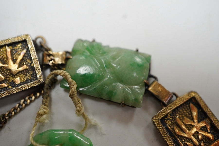 A Chinese gilt white metal and carved jade panel set bracelet, a.f, 17.5cm, together with a carved jade pendant, 40mm. Condition - poor to fair